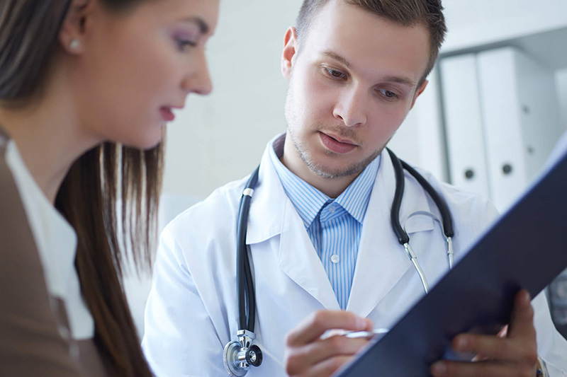 doctor and patient discussing cholesterol results doctor and patient discussing cholesterol results
