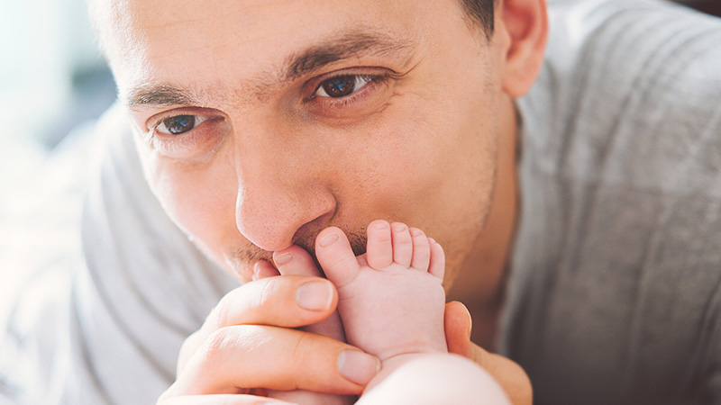 father kisses baby foot father kisses baby foot