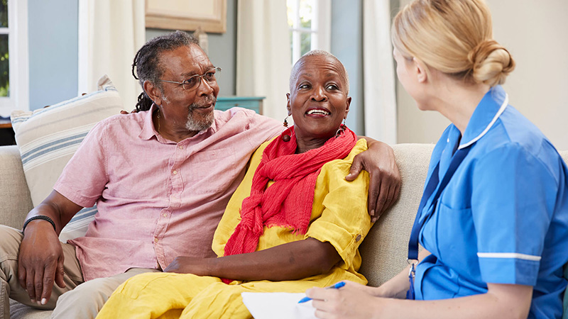 nurse talking to senior couple nurse talking to senior couple