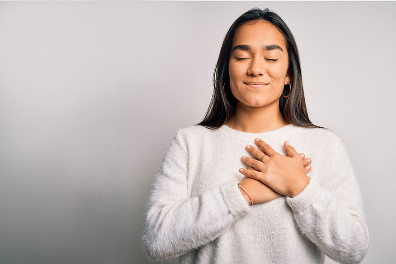 thankful woman with hand over heart thankful woman with hand over heart