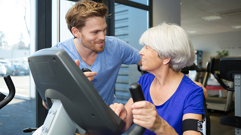 therapist with senior woman exercising therapist with senior woman exercising